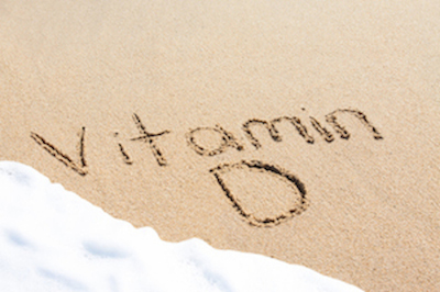 Vitamin D written in the sand